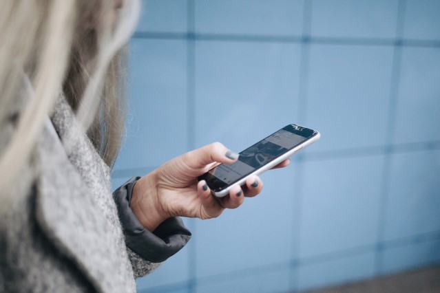 woman checking social media on iphone